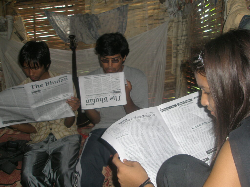 Bhutanese refugees reading a copy of The Bhutan Reporter in the Beldangi-II refugee camp. Photo by TP Mishra.
