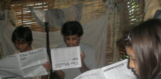 Bhutanese refugees reading a copy of The Bhutan Reporter in the Beldangi-II refugee camp. Photo by TP Mishra.