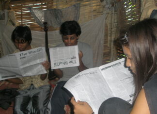 Setting up refugee media in exile Bhutanese refugees reading a copy of The Bhutan Reporter in the Beldangi-II refugee camp. Photo by TP Mishra.