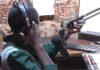 Editing radio news bulletins Journalist Bakhita Aluel adjusting the microphone at Radio Easter in Yei in South Sudan