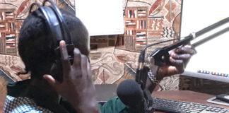 Editing radio news bulletins Journalist Bakhita Aluel adjusting the microphone at Radio Easter in Yei in South Sudan