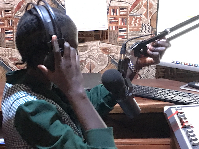 Journalist Bakhita Aluel adjusting the microphone at Radio Easter in Yei in South Sudan