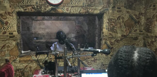 Journalists James Innocent Ali (background) and Bakhita Aluel recording links at Radio Easter in South Sudan.