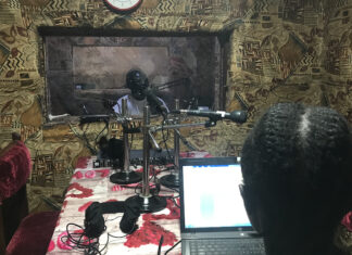 Editing audio for radio news Journalists James Innocent Ali (background) and Bakhita Aluel recording links at Radio Easter in South Sudan.