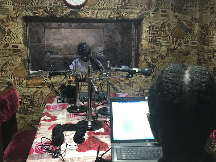 Journalists James Innocent Ali (background) and Bakhita Aluel recording links at Radio Easter in South Sudan.