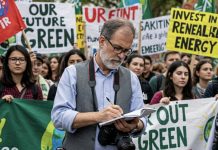 Climate change – tone and language Image of a journalist reporting on a climate change rally created with Gemini Imagen 3 AI by Media Helping Media