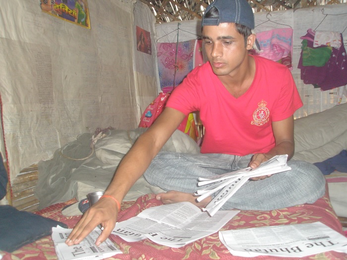 Puspa Adhikari of The Bhutan Reporter arranging copies of the paper - Photo TP Mishra