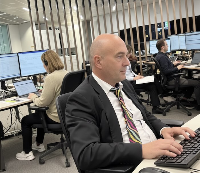 Image of editor working in a newsroom - created with an original image and Google Gemini AI