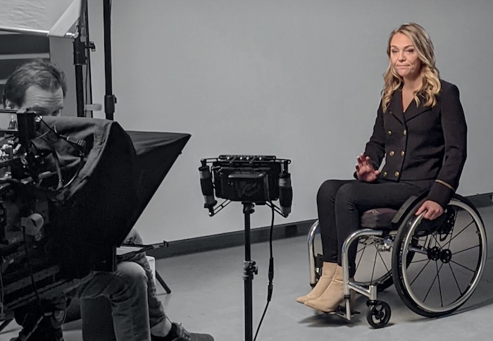 Journalist reporting on camera from a wheelchair - image by UNESCO released via Creative Commons BY-SA-3.0