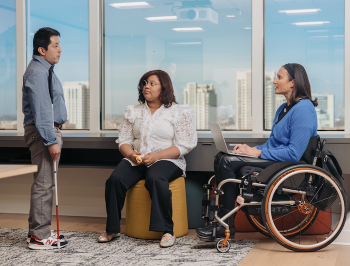 Three colleagues chat in newsroom - image by UNESCO released via Creative Commons BY-SA-3.0