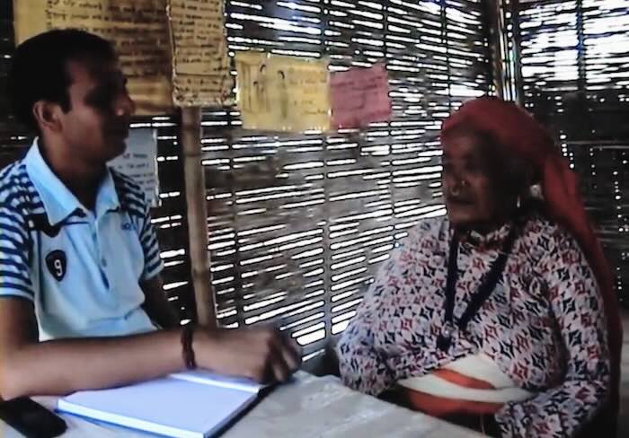The author interviewing an elderly Bhutanese mother in a refugee camp in Jhapa, Nepal, in 2009