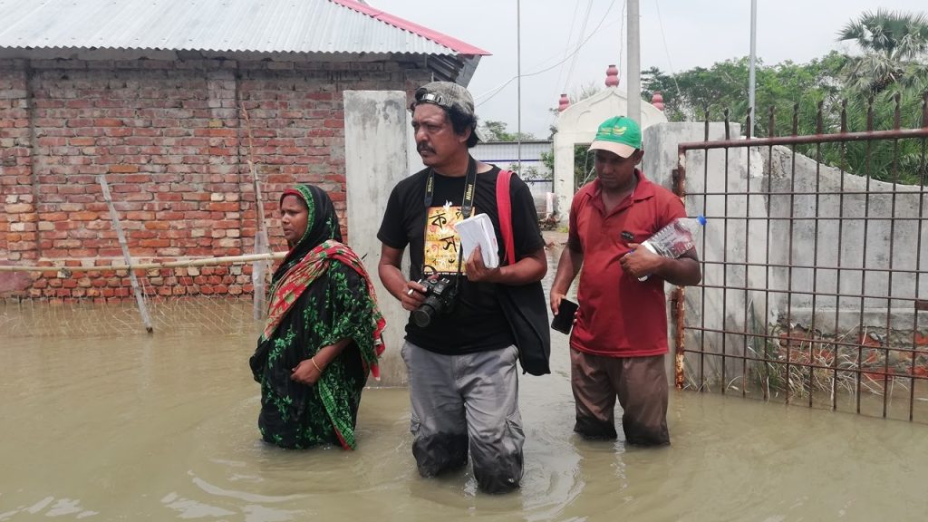 The author - Rafiqul Islam Montu - with coastal flooding victims