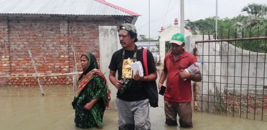 The author - Rafiqul Islam Montu - with coastal flooding victims